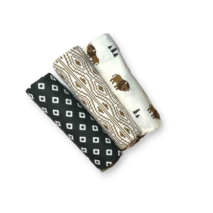 Hey Baby Box set of 3 baby swaddles: black with white diamond pattern, cream with geometric pattern, and white with bison and tree print.