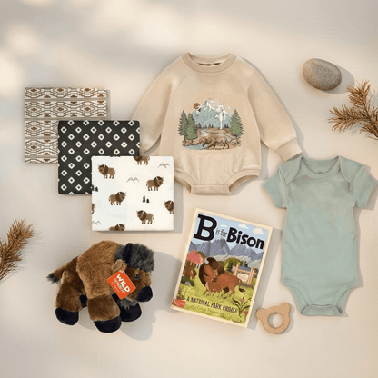 Baby clothing and toys with a nature-themed design on a light background