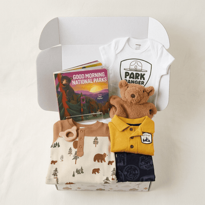 Baby clothing and toy set with 'PARK RANGER' themed items in a box.