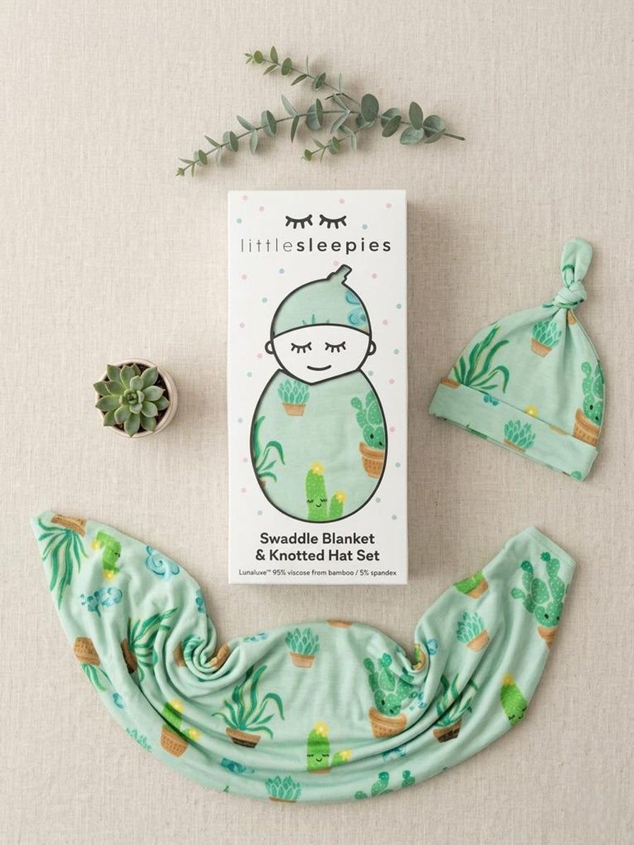 Swaddle blanket and knotted hat set with cactus pattern on a beige background, featuring 'littlesleepies' packaging.