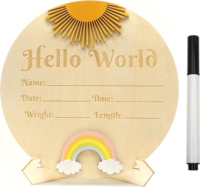Round wooden board with 'Hello World' text, rainbow, sun, and cloud decorations, accompanied by a marker.