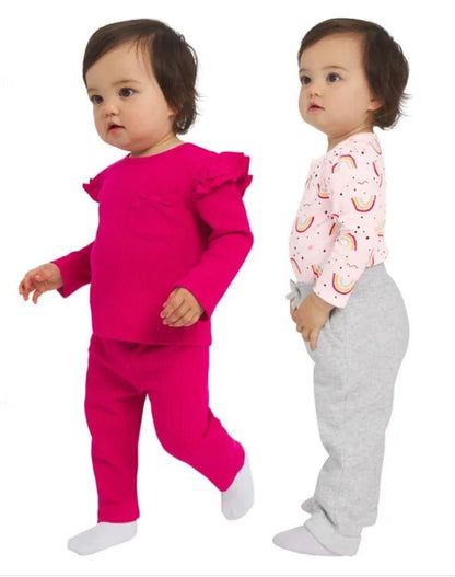 Two children wearing bright pink and gray outfits on a white background