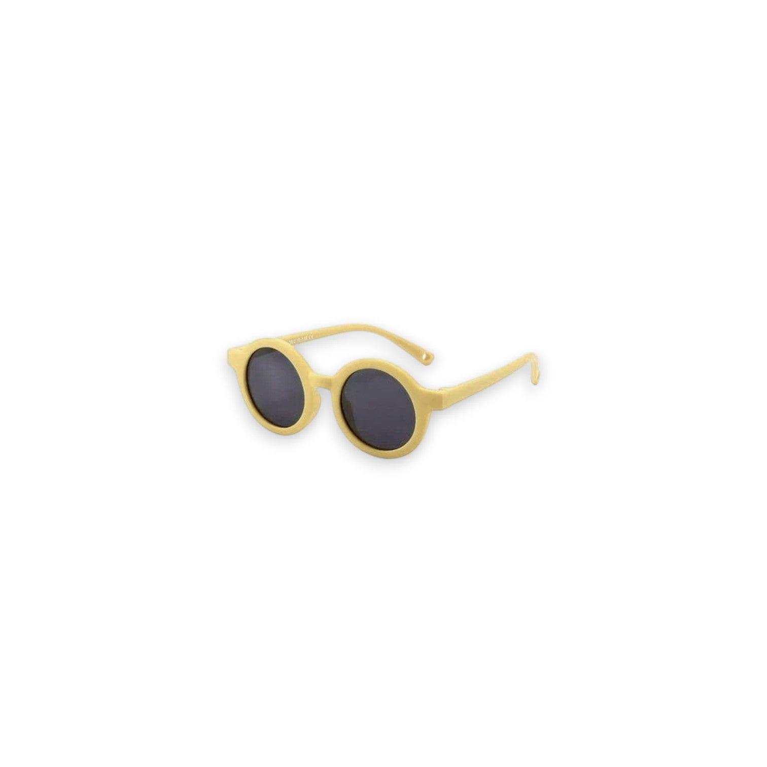 Small round sunglasses with gold frame and dark lenses on a white background