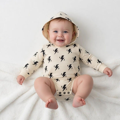 Hey Baby Box cream hooded onesie with black lightning bolt print and front pocket. Soft cotton blend.