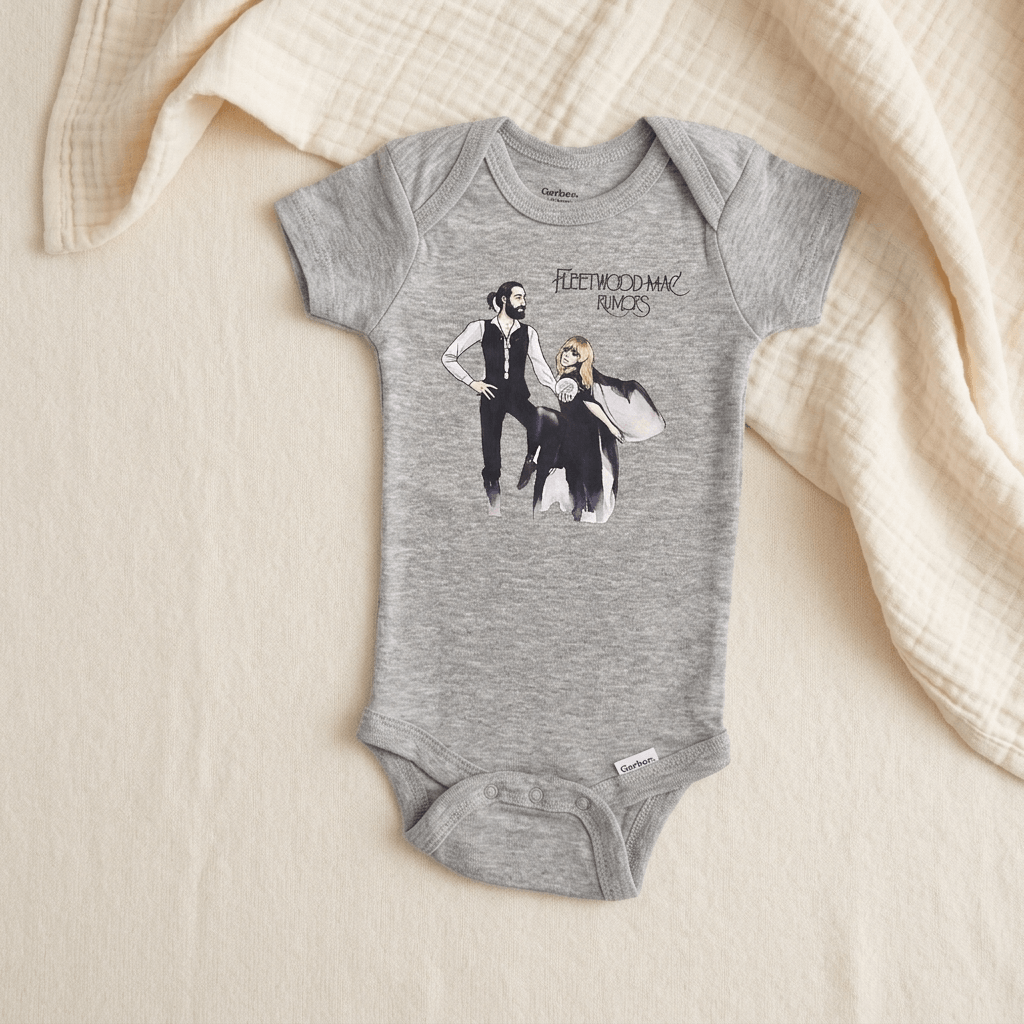 A heather gray baby bodysuit featuring a graphic print of the band Fleetwood Mac with the text 'Fleetwood Mac Rocks' and an illustration of the band members, laid flat on a cream-colored textured blanket.