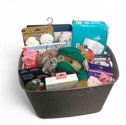 Curated baby gift basket with plush toys, diapers, teething toys, and baby essentials for newborns and baby showers