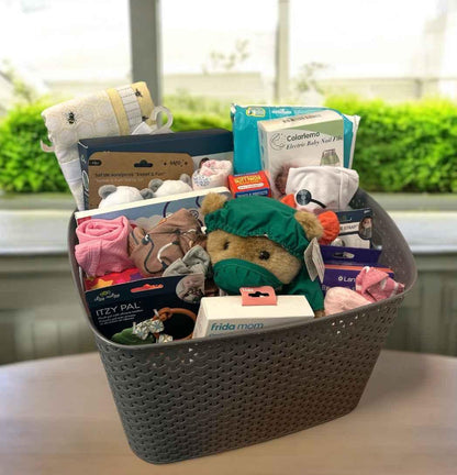 Curated baby gift basket with plush toys, baby essentials, and themed items for newborns and baby showers