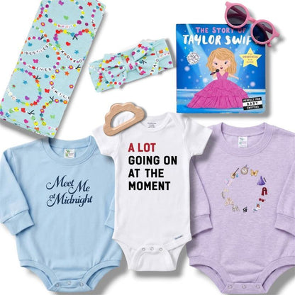 Collection of baby items including onesies, a book, and sunglasses on a white background