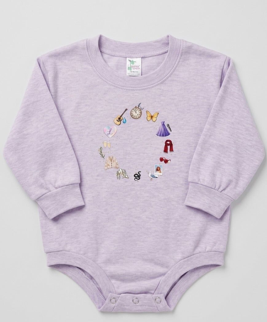 Purple baby onesie with embroidered designs on a light gray background