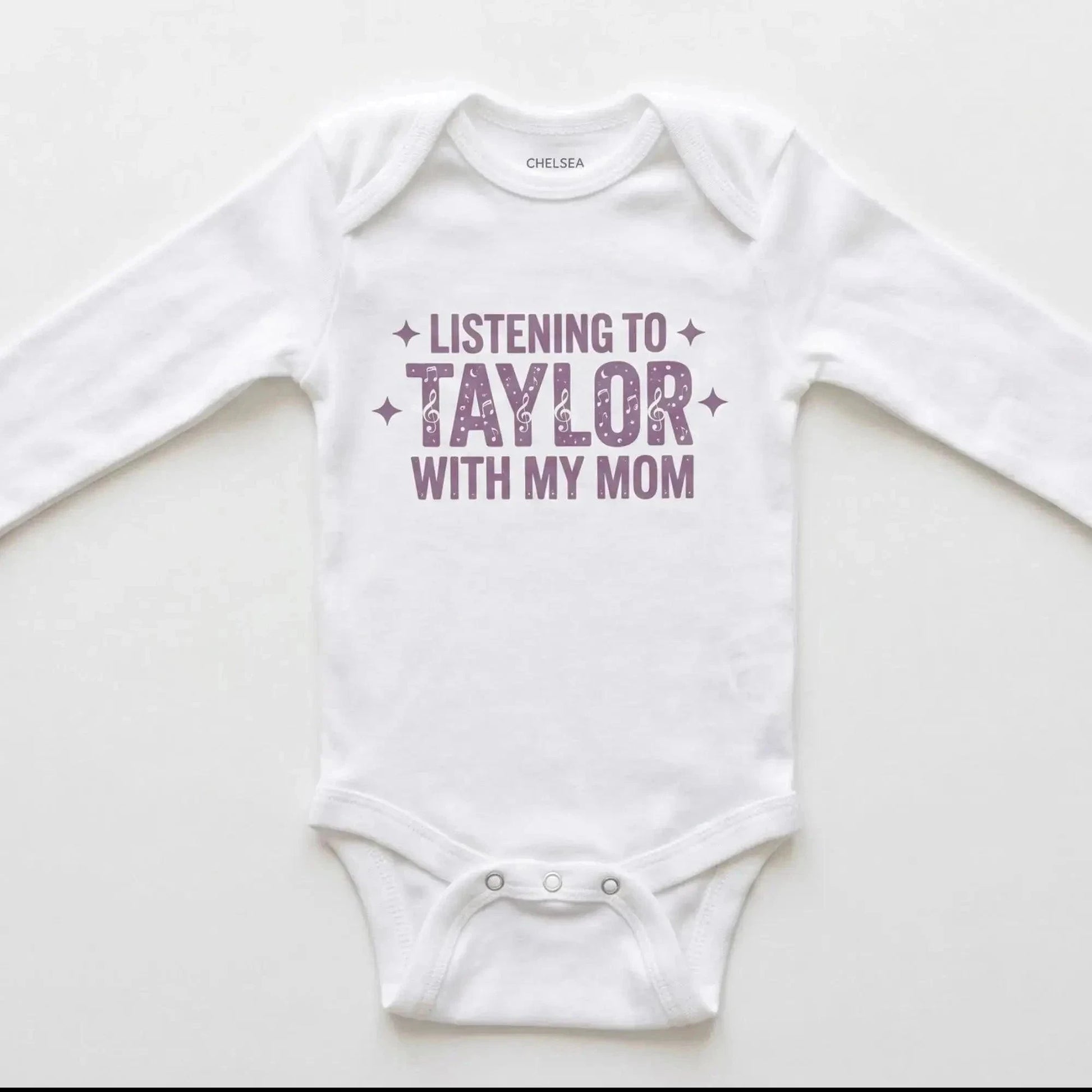 White baby onesie with 'Listening to Taylor with my mom' text on a white background