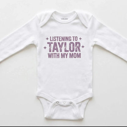 White baby onesie with 'Listening to Taylor with my mom' text on a white background