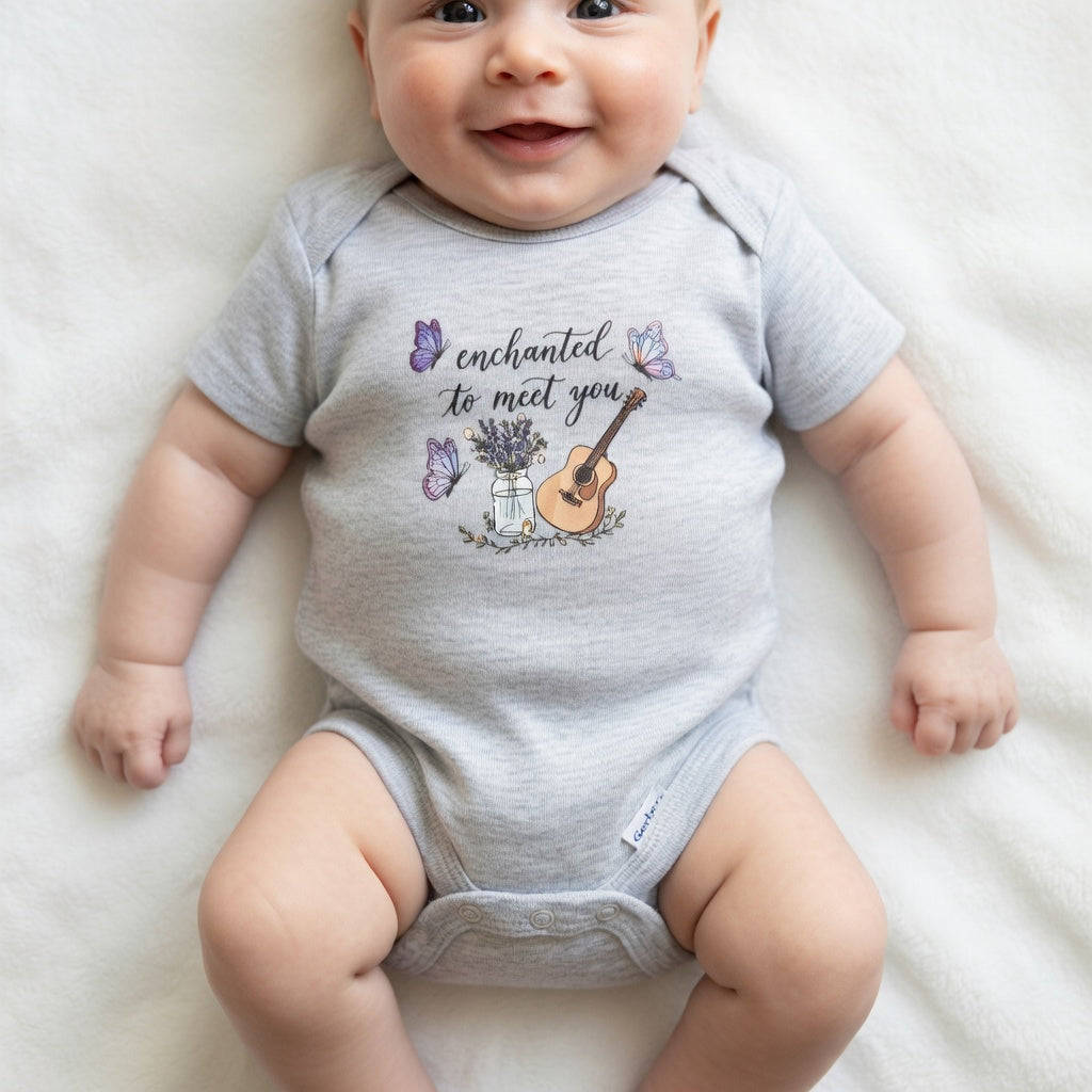 Baby wearing a gray onesie with a printed design on a white background