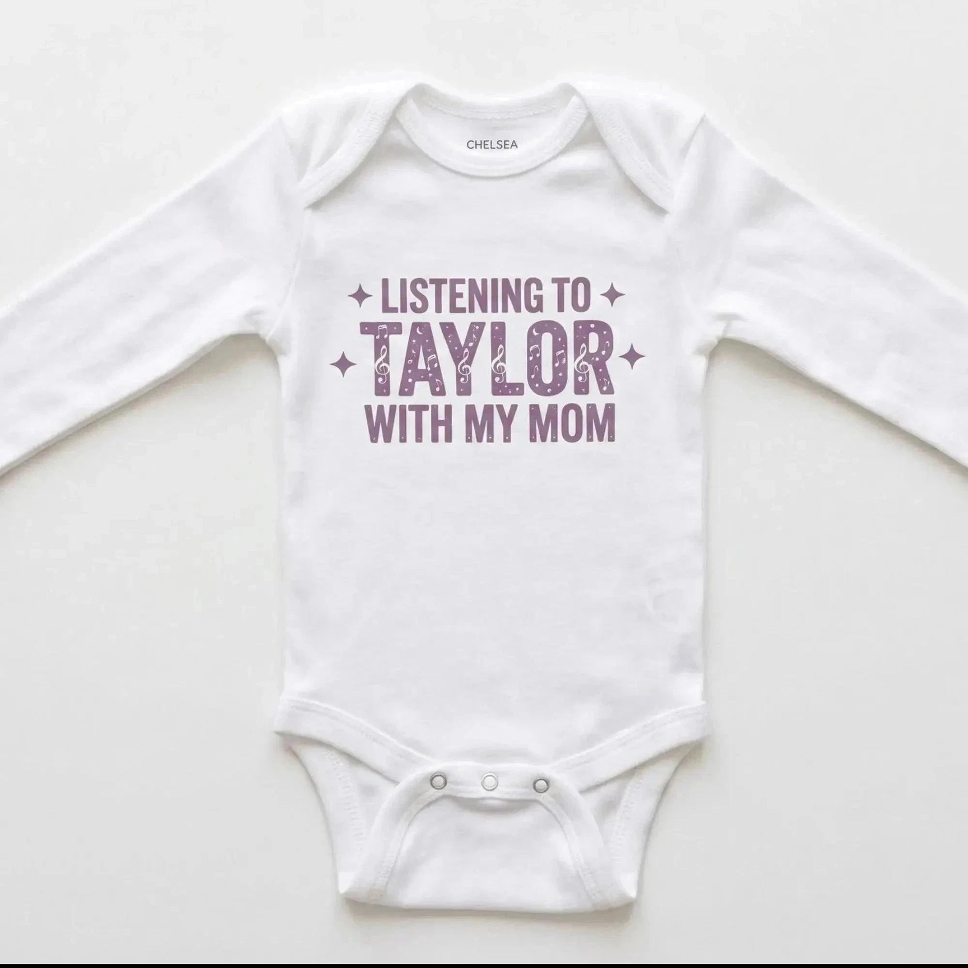 White baby onesie with 'Listening to Taylor with my mom' text on a white background