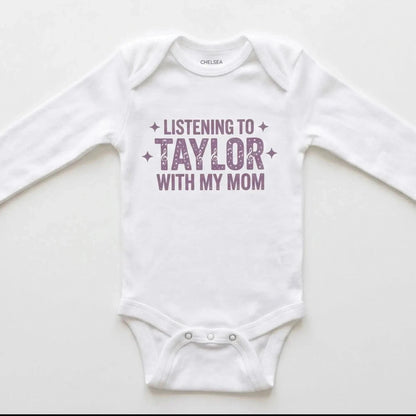 White baby onesie with 'Listening to Taylor with my mom' text on a white background