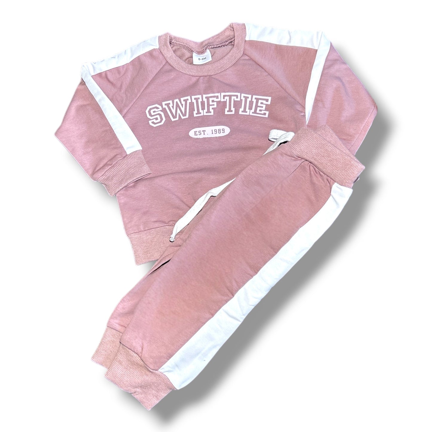 Pink 'SWIFTIE' tracksuit with white accents on a white background