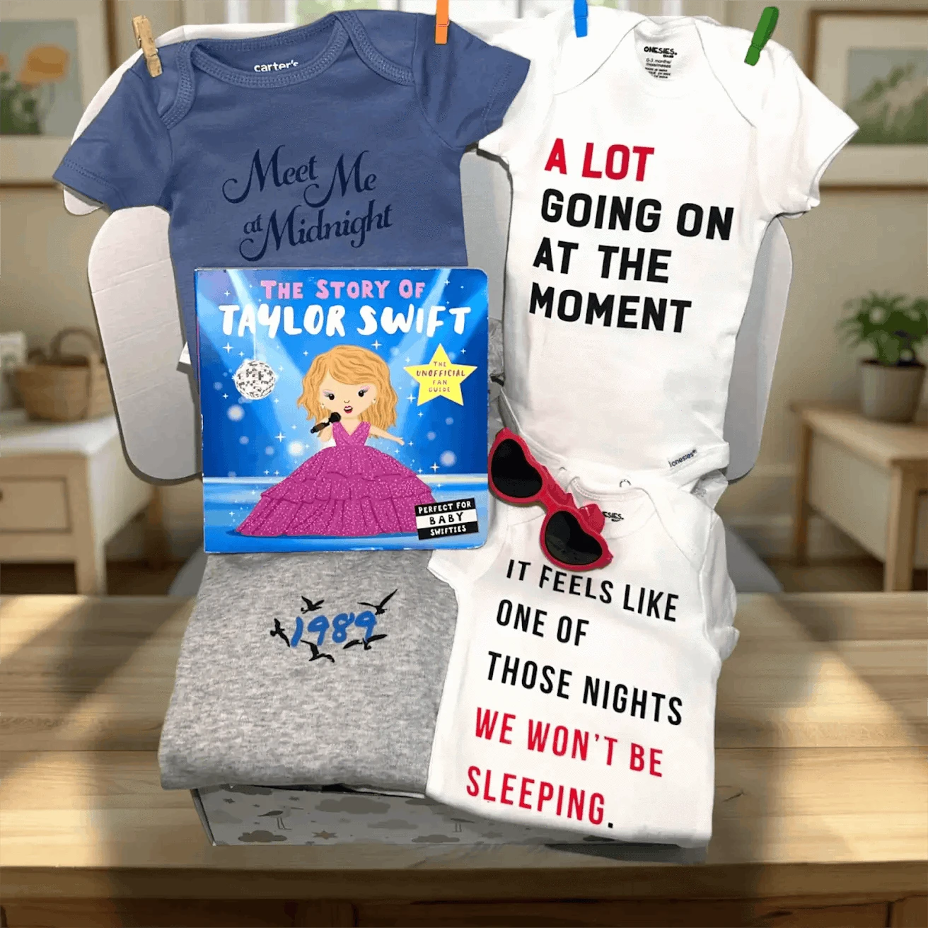 Four baby onesies with humorous text designs on a table.