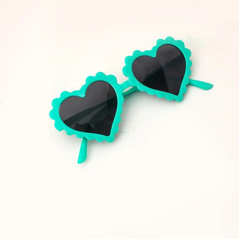 Turquoise heart-shaped sunglasses on a white background