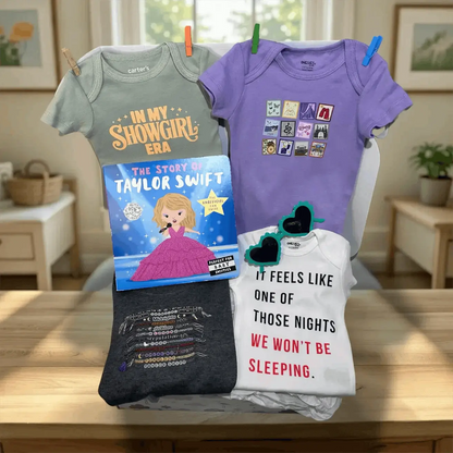 Collection of baby clothes and a book on a table with a home setting in the background