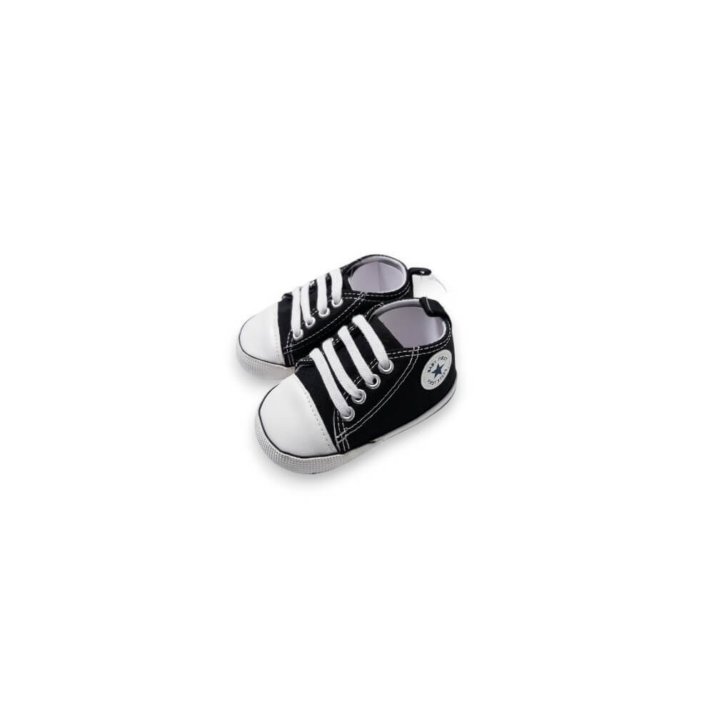 A pair of miniature black and white toy sneakers designed to look like classic low-top canvas shoes, shown on a plain white background.