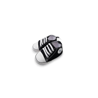 A pair of miniature black and white toy sneakers designed to look like classic low-top canvas shoes, shown on a plain white background.
