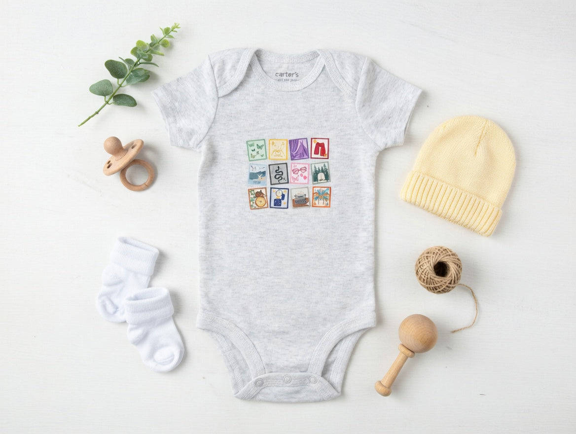 Baby onesie with colorful graphic, yellow hat, white socks, wooden rattle, and pacifier on a light background