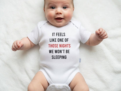 Baby wearing a onesie with text on a white background