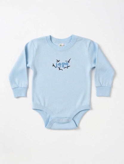 Light blue baby onesie with bird design on a white background