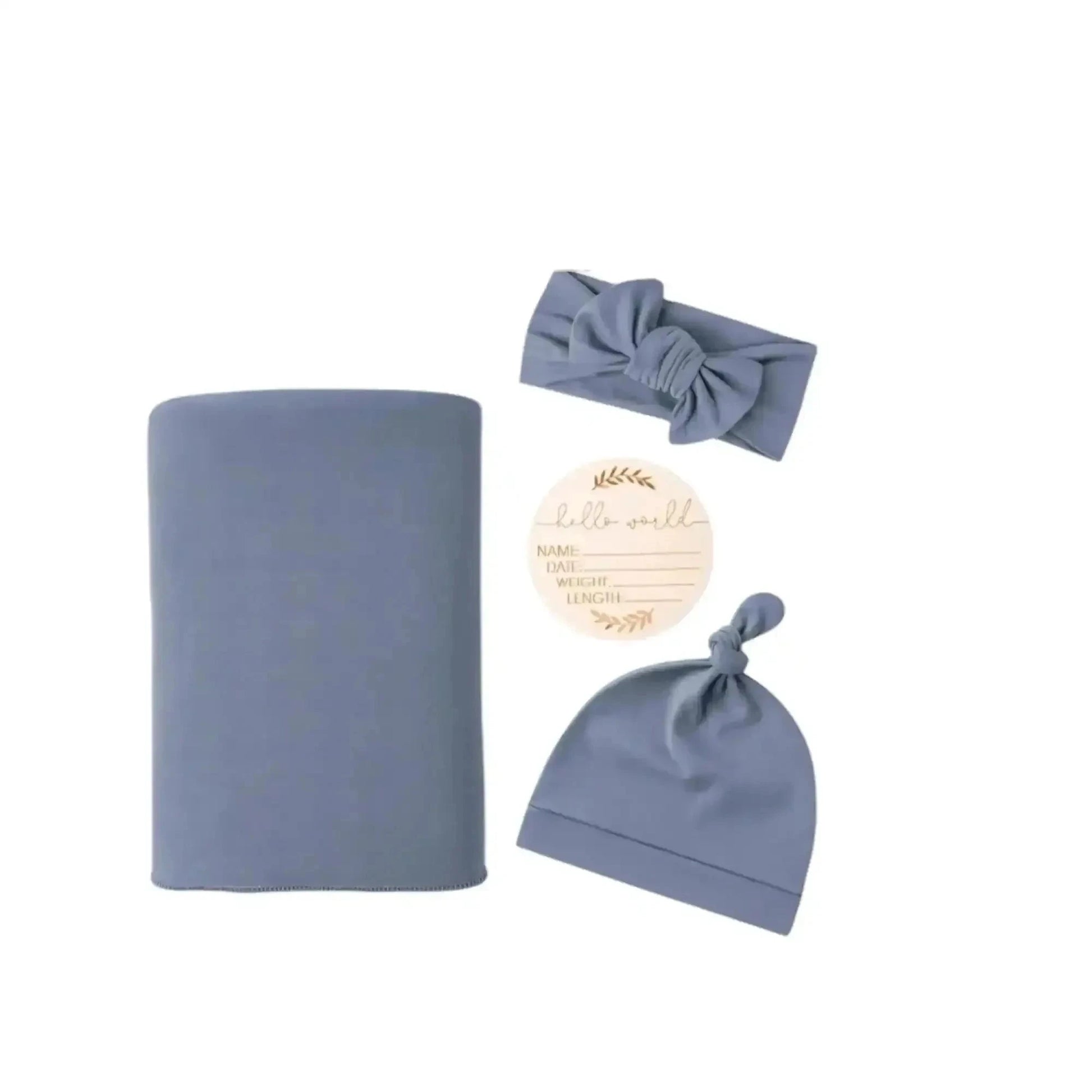 Dusty blue baby gift set with swaddle, knotted hat, headband, and keepsake card for newborns